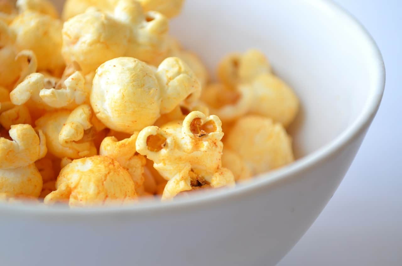 Bowl of popcorn sitting on a white table
