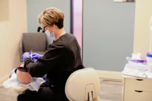 Dental assistant working on patient's teeth